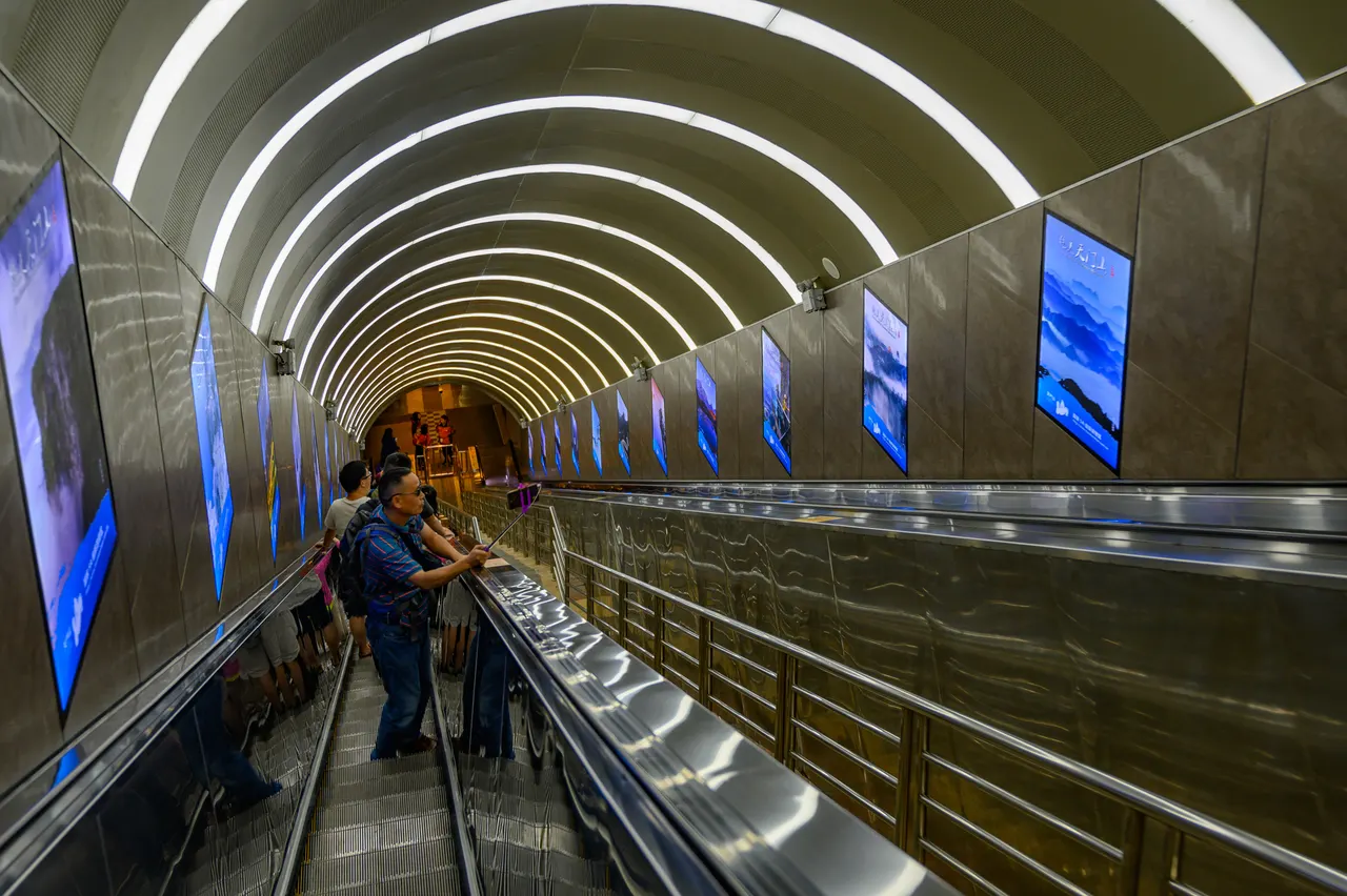 Visitors standing on an escalator inside Tianmen Mountain